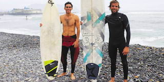two surfers on the beach