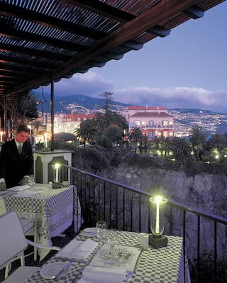 Belmond Reid S Palace Top Luxury Hotels In Madeira A Little Taste Of Italy On The Edge Atlantic This Is Spot To Dine Alfresco Overlooking Layers Blue As Waiter Lights Your Table Top